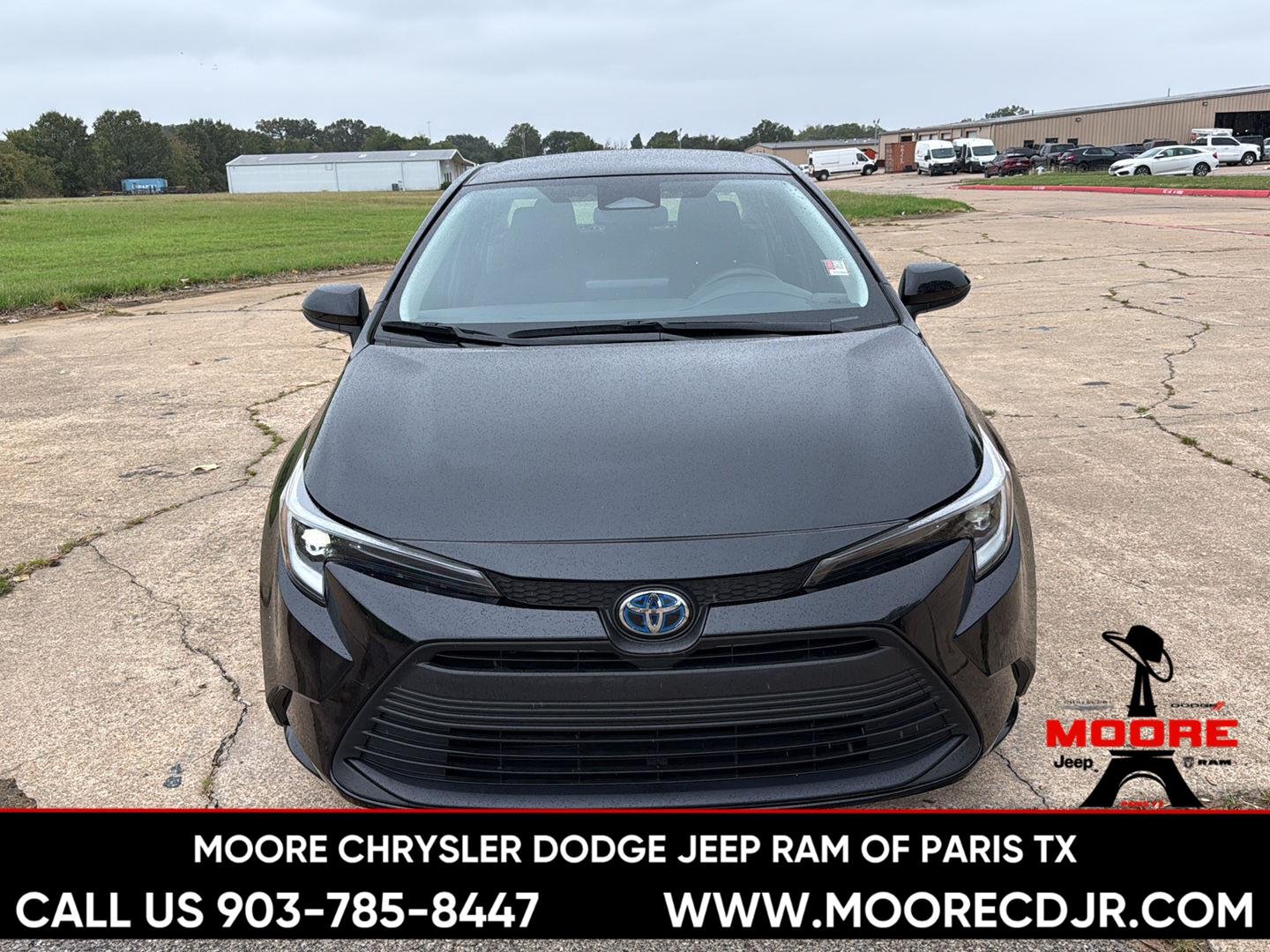 Used 2025 Midnight Black Metallic Toyota Hybrid LE image 2