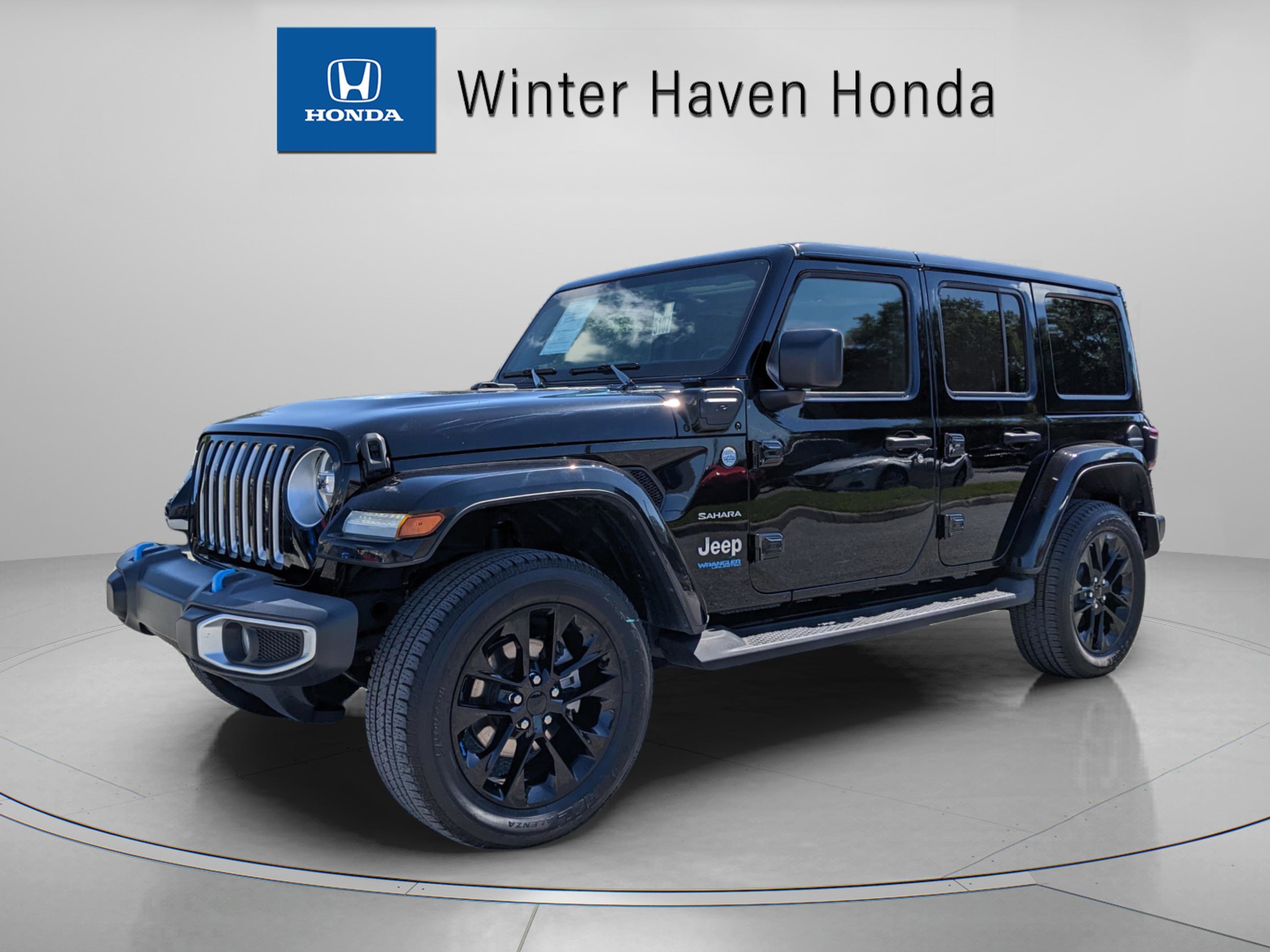 Used 2022 Jeep Wrangler Unlimited Sahara 4XE with VIN 1C4JJXP6XNW198837 for sale in Winter Haven, FL