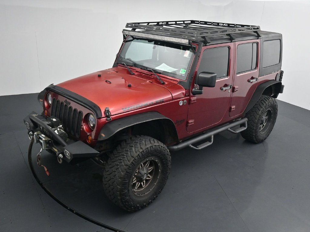 Used 2012 Red Jeep Unlimited Sport image 12