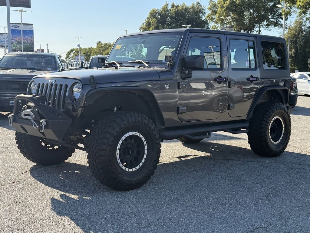 Used 2016 Granite Crystal Clearcoat Metallic Jeep Unlimited Sport image 3