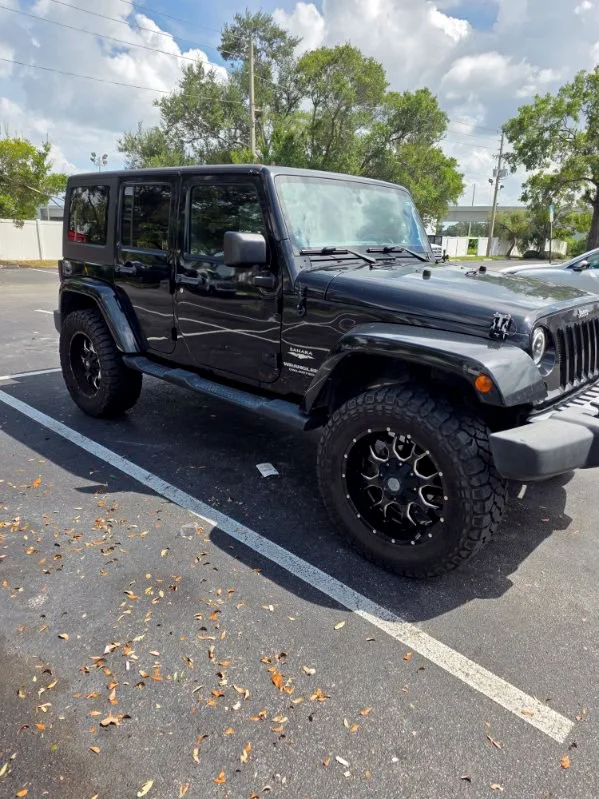 Used 2014 Black Jeep Unlimited Sahara image 3
