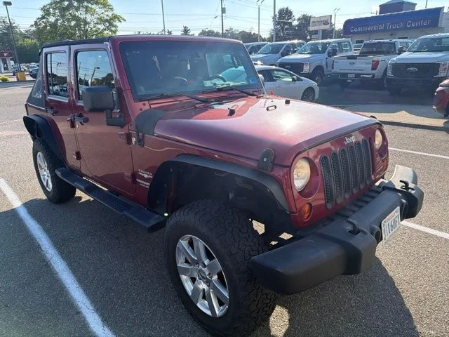 Used 2013 Red Jeep Unlimited Sahara image 1
