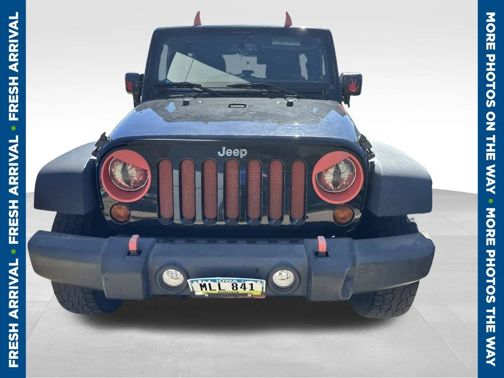 Used 2013 Black Jeep Unlimited Sport image 1