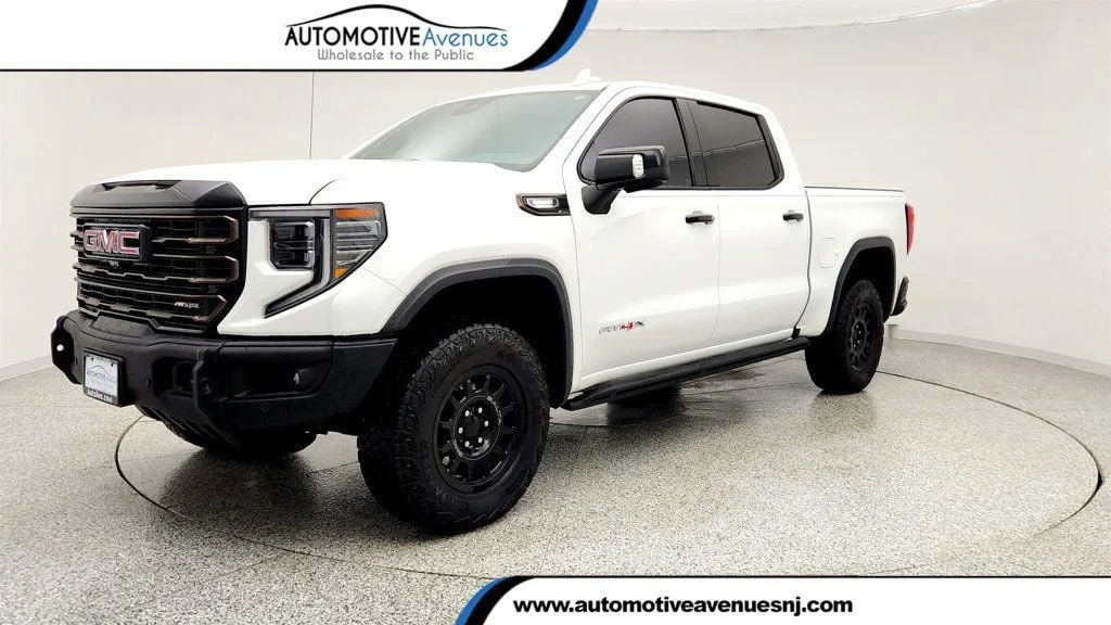 Used 2024 Summit White GMC 4WD Crew Cab 147"" AT4X image 1