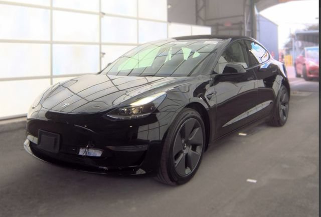Used 2023 Solid Black Tesla Base image 1