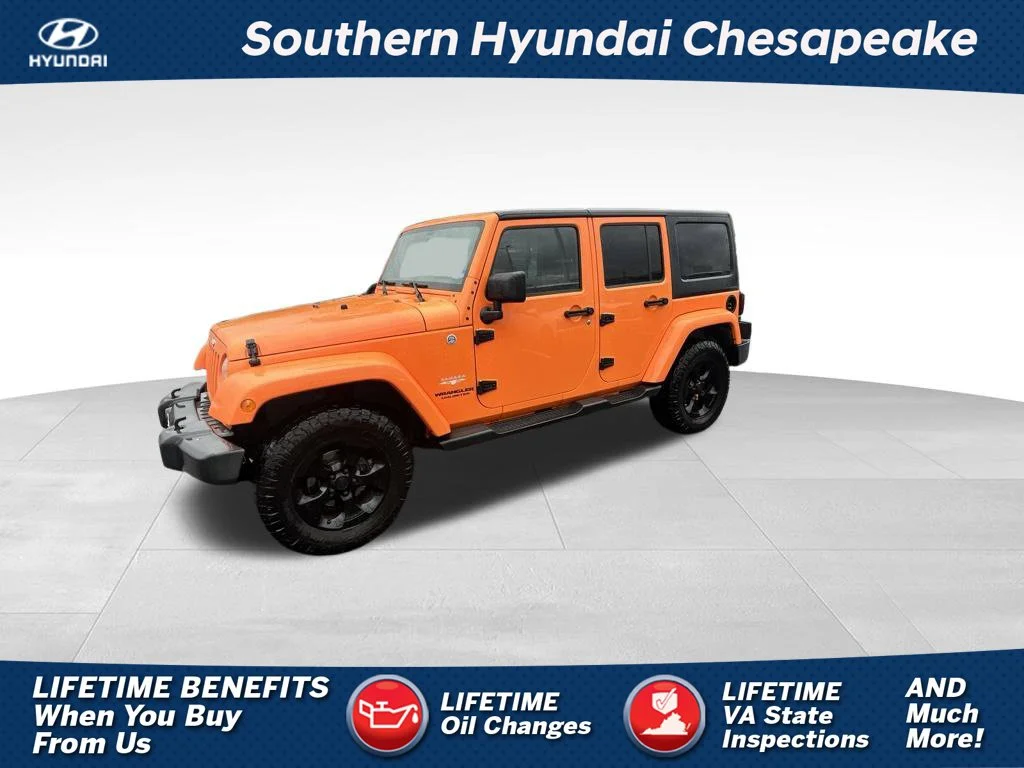 Used 2013 Orange Jeep Unlimited Sahara image 1