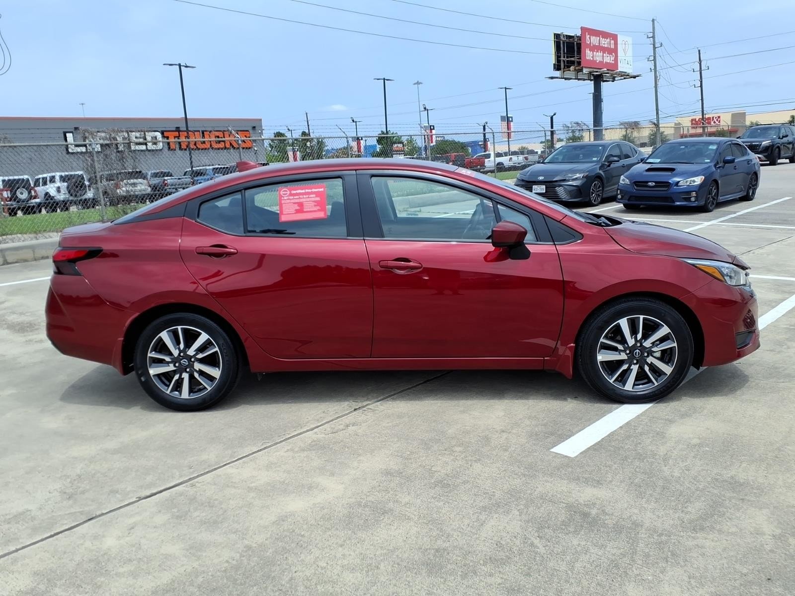 2025 Nissan Versa SV Red at Robbins Nissan