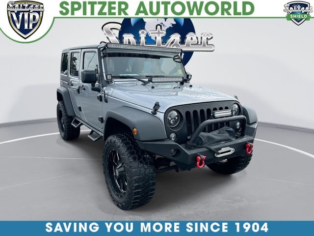 Used 2015 Silver Jeep Unlimited Sport image 1