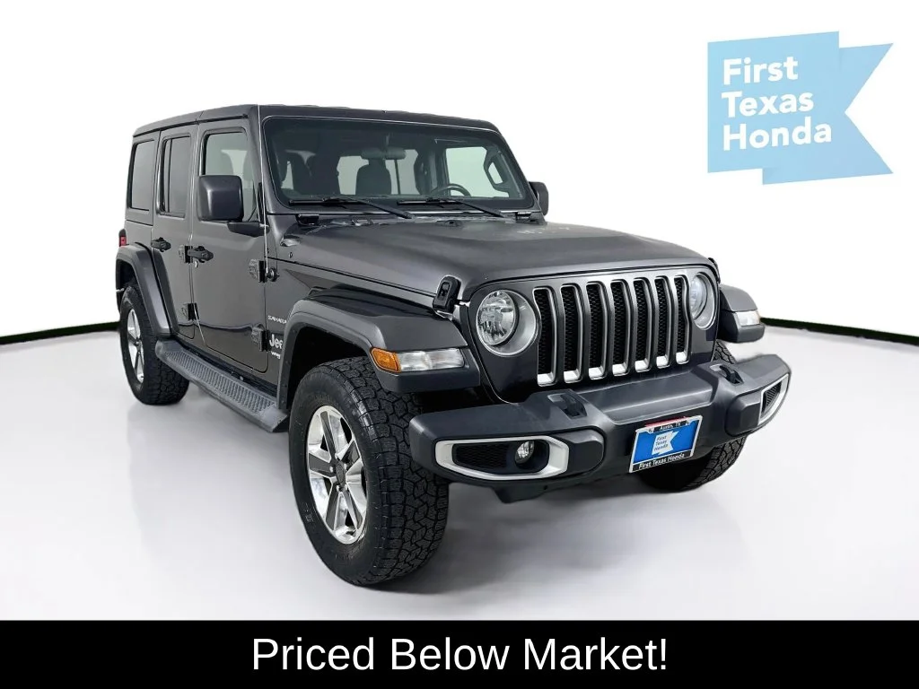 Used 2018 Granite Crystal Metallic Clearcoat Jeep Unlimited Sahara image 1