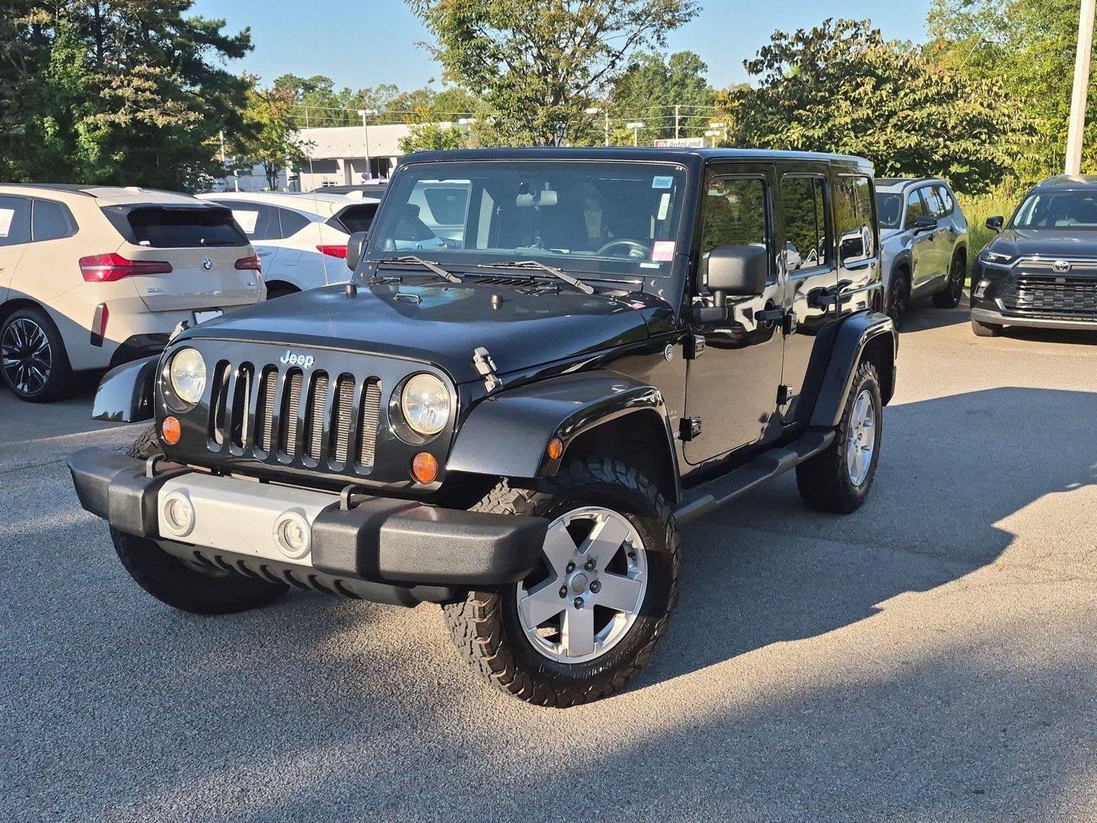 Used 2011 Black Clear Coat Jeep Sahara image 1