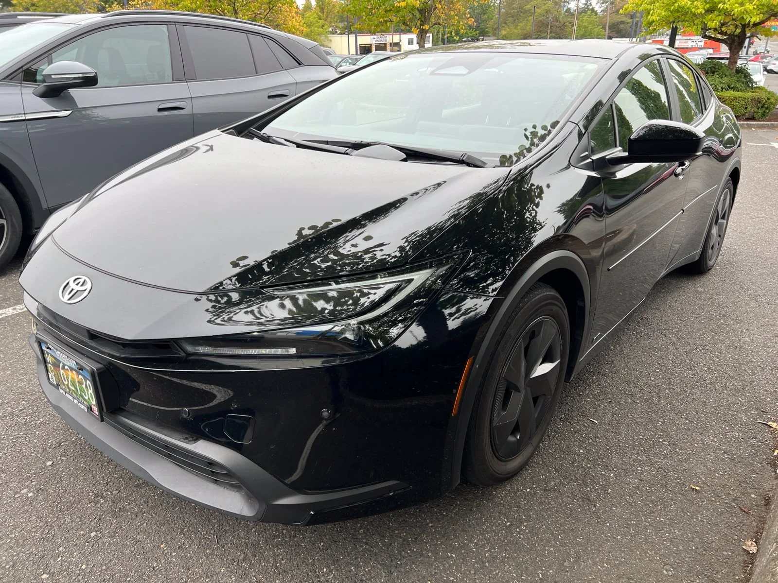 Used 2024 Midnight Black Metallic Toyota LE image 1