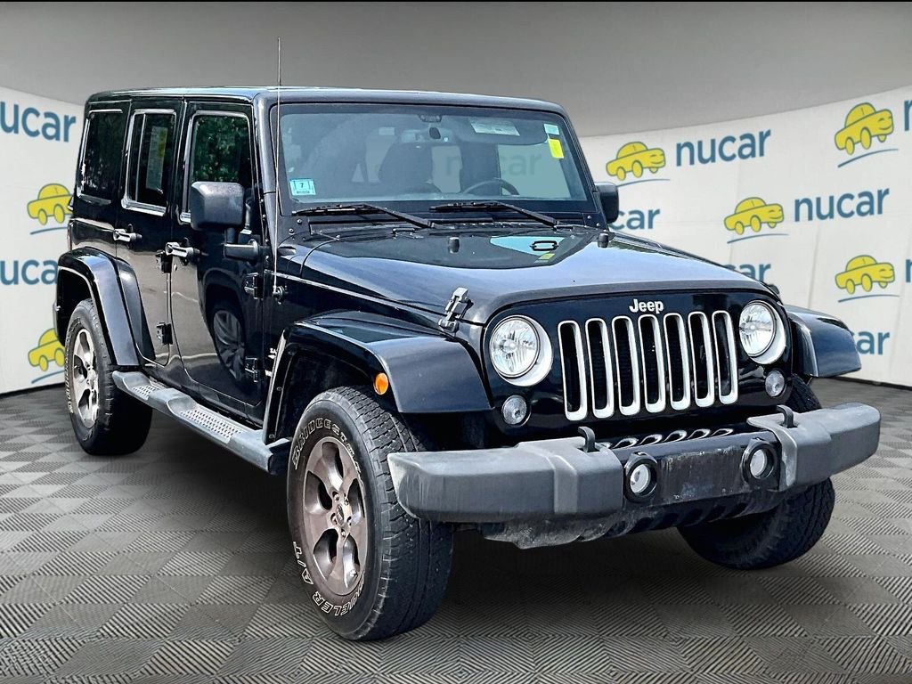 Used 2016 Black Jeep Unlimited Sahara image 1