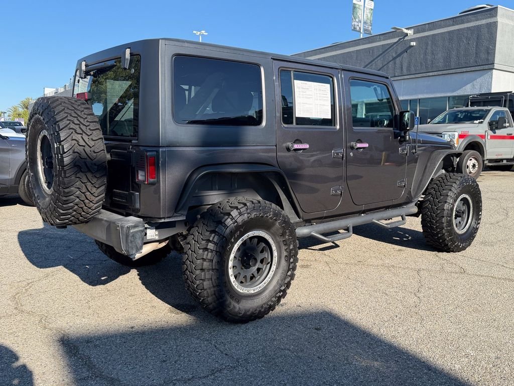 Used 2016 Granite Crystal Clearcoat Metallic Jeep Unlimited Sport image 6