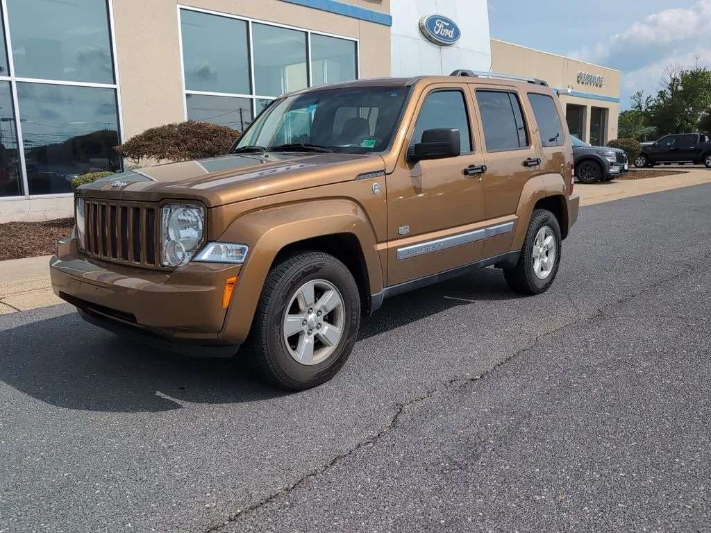 Used 2011 Brown Jeep Sport image 1