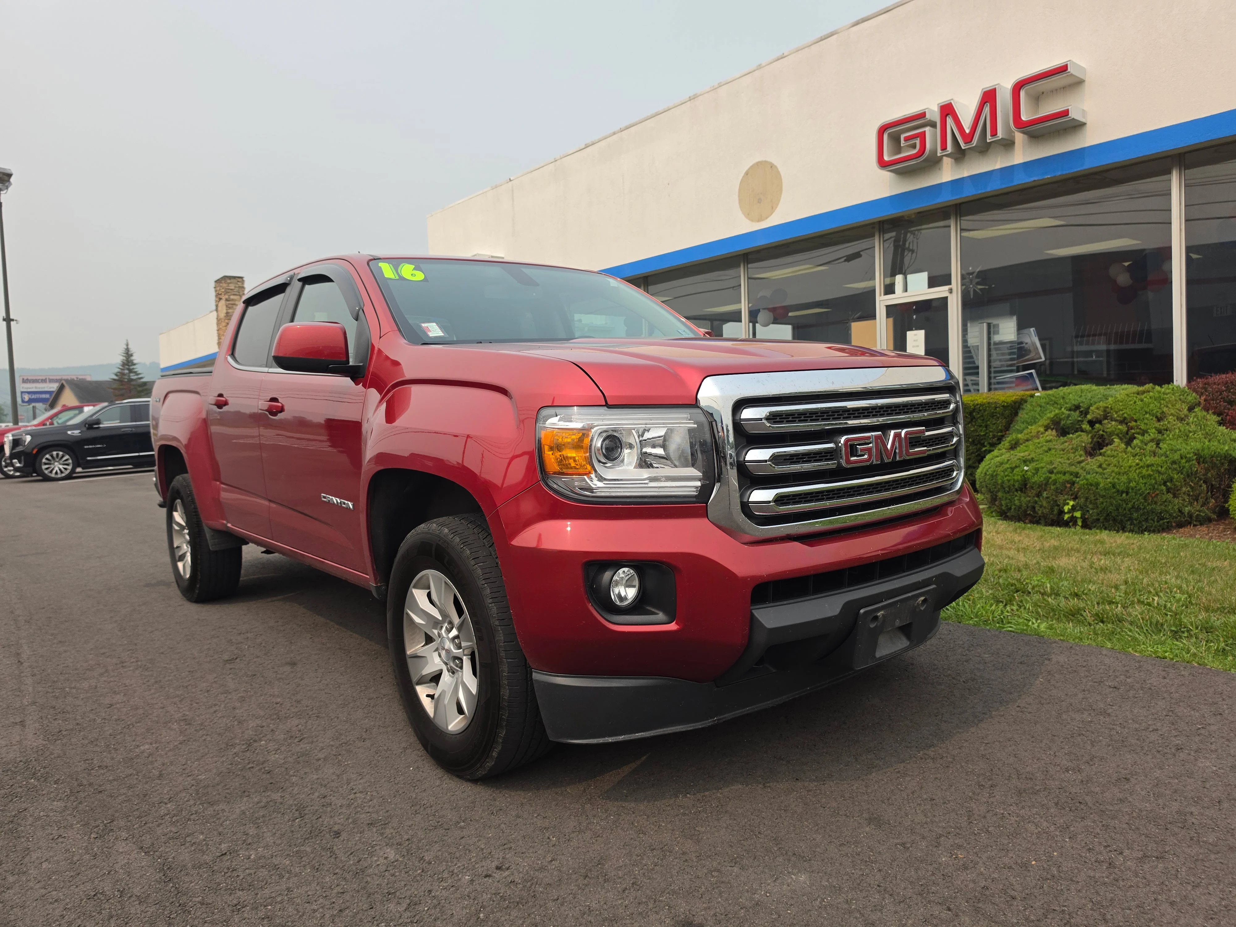Used 2016 Copper Red Metallic GMC 4WD SLE image 1