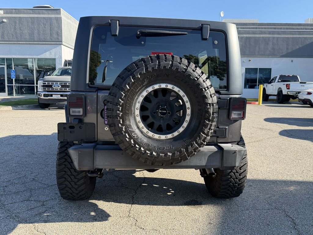 Used 2016 Granite Crystal Clearcoat Metallic Jeep Unlimited Sport image 5