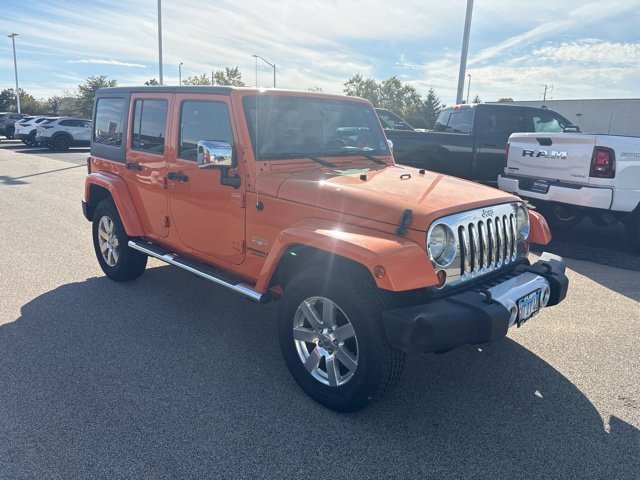 Used 2012 Orange Jeep Unlimited Sahara image 3