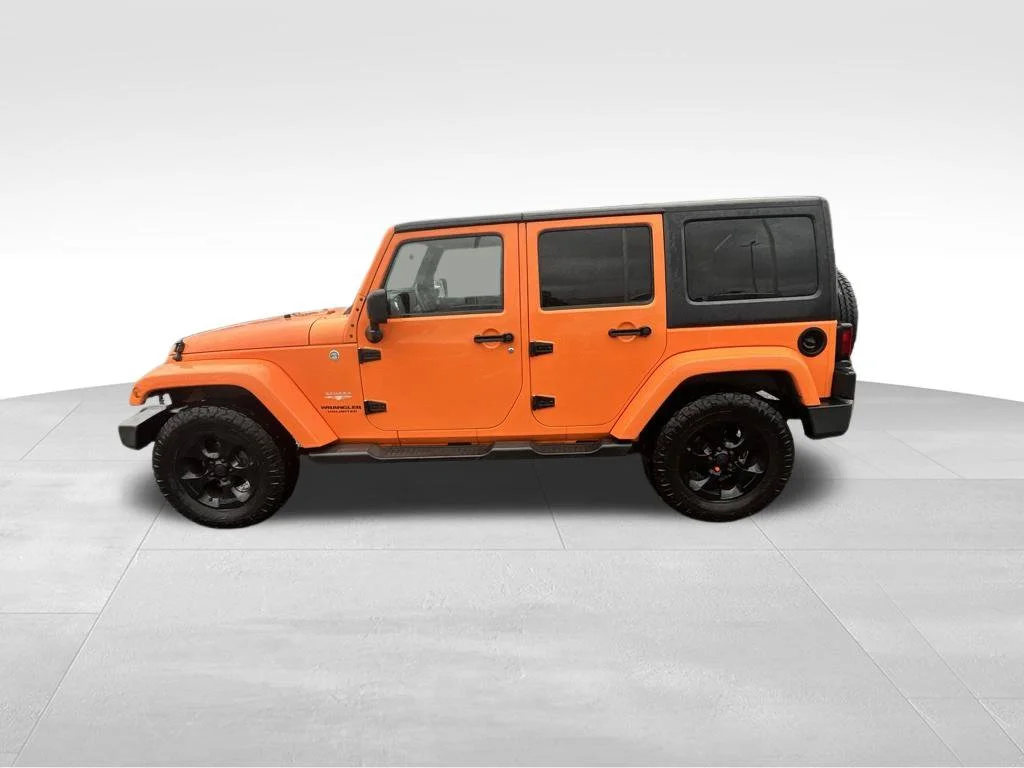 Used 2013 Orange Jeep Unlimited Sahara image 5