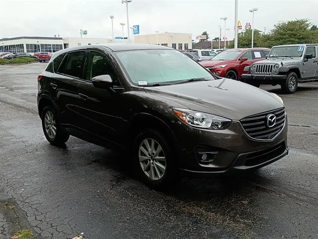 Used 2016 Titanium Flash Mica Mazda Touring image 1