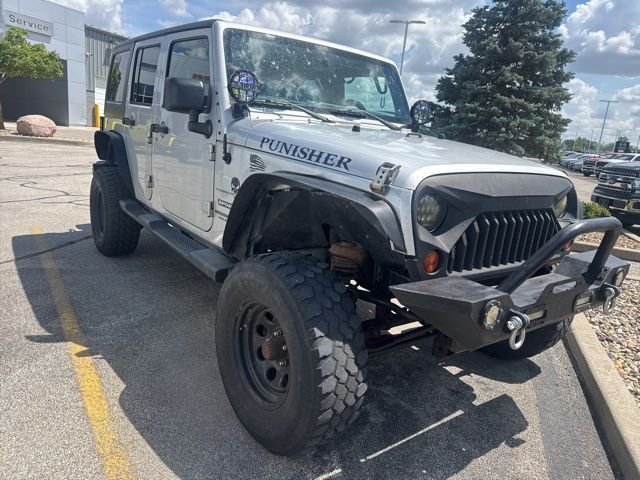 Used 2011 Silver Jeep Unlimited Sport image 1