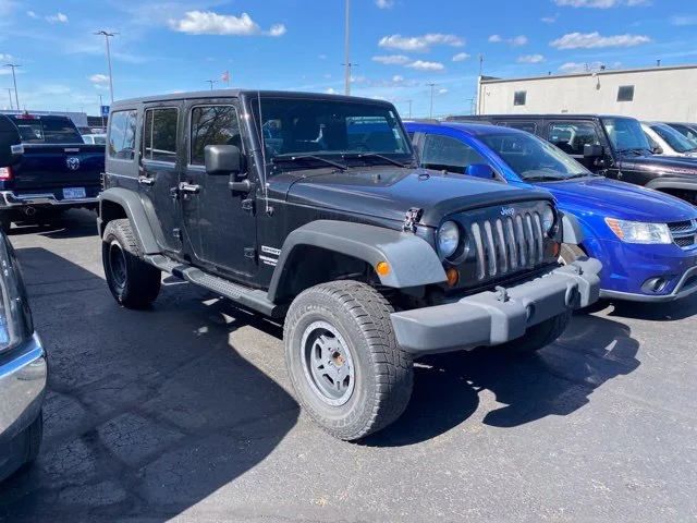 Used 2013 Black Jeep Unlimited Sport image 1