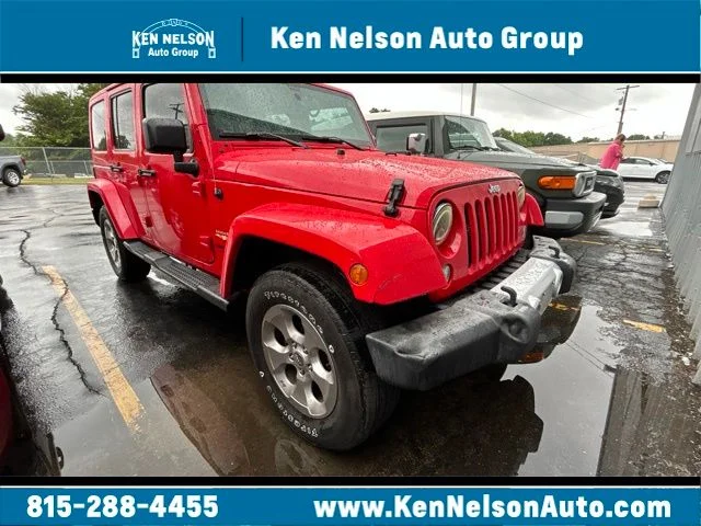 Used 2015 Red Jeep Unlimited Sahara image 1