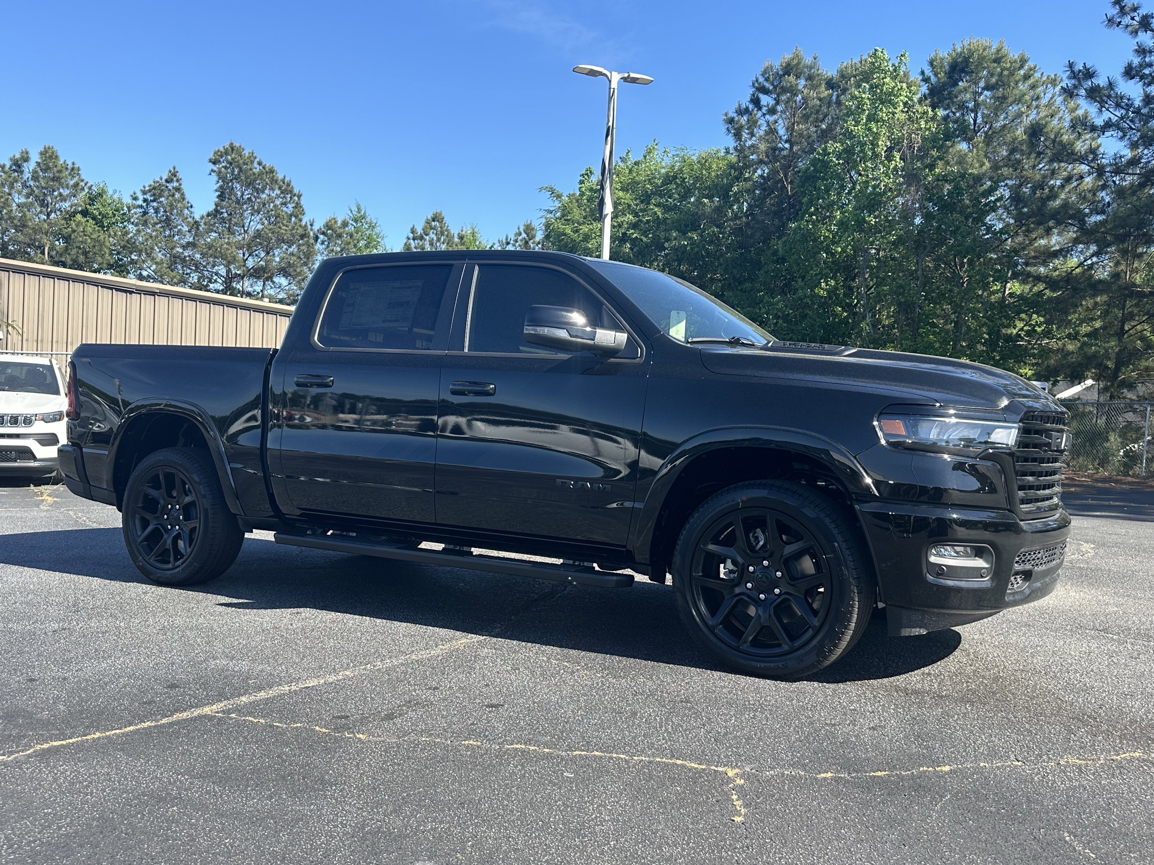 New 2026 Diamond Black Crystal Pearl-Coat Exterior Paint RAM Laramie image 2