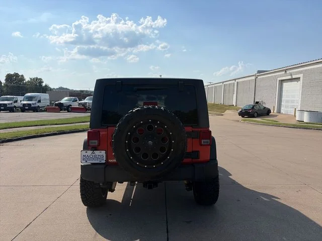 Used 2015 Orange Jeep Unlimited Sport image 4