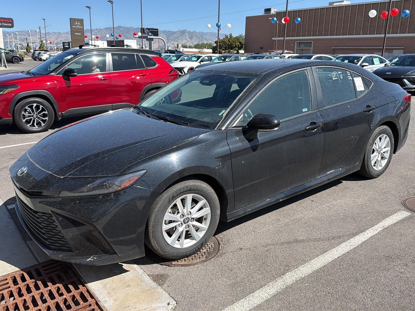 Used 2025 Midnight Black Metallic Toyota LE image 1