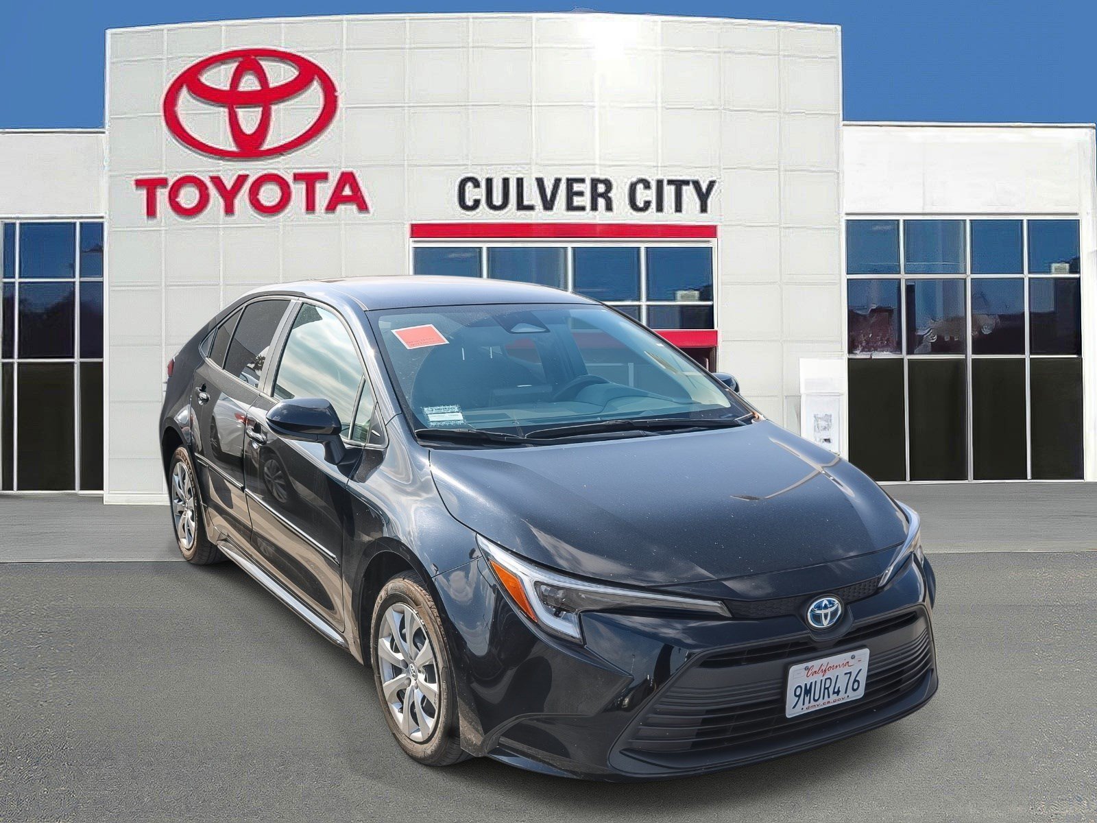 Used 2024 Midnight Black Metallic Toyota Hybrid LE image 1